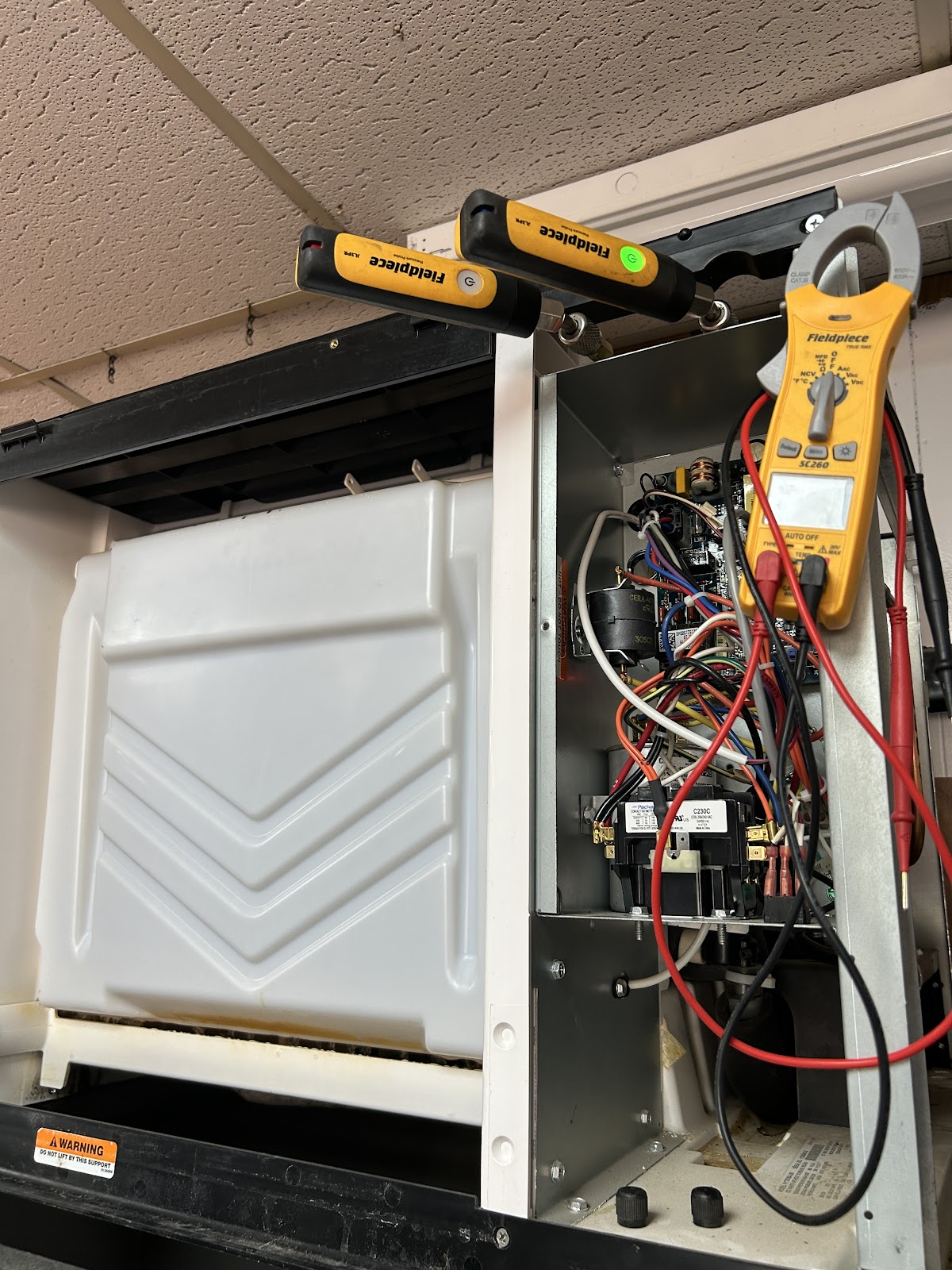 Fieldpiece probes testing air handler control board and contactor