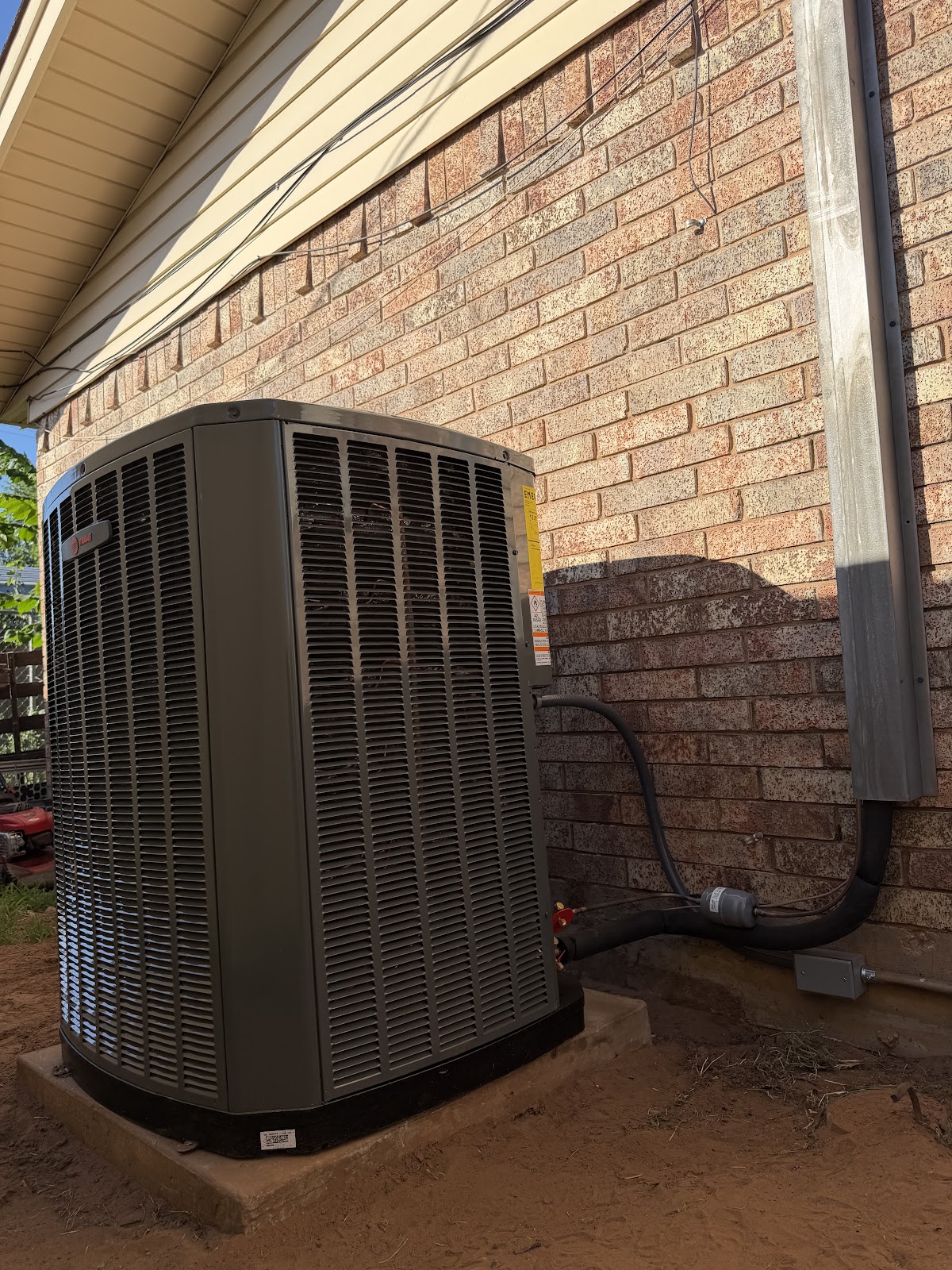 Armando servicing Texas residential AC condensing unit